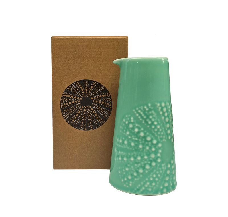 a medium sized aqua jug for oils, milk, salad dressing with a textured kina pattern