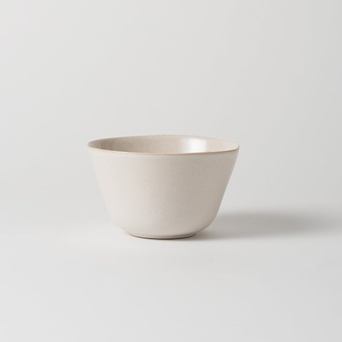 A white ceramic cereal bowl with a subtle natural tone