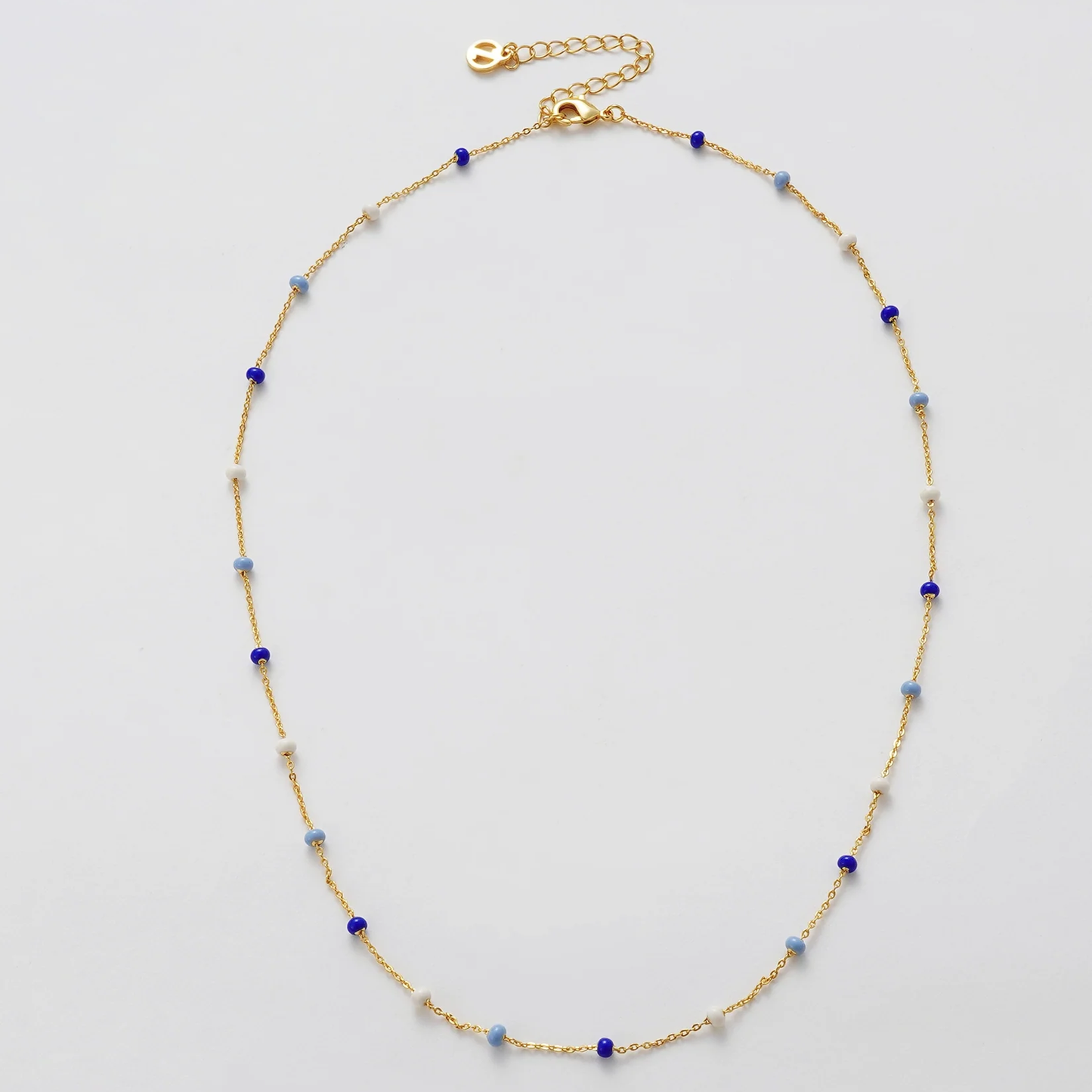 Gold necklace with blue and white beads