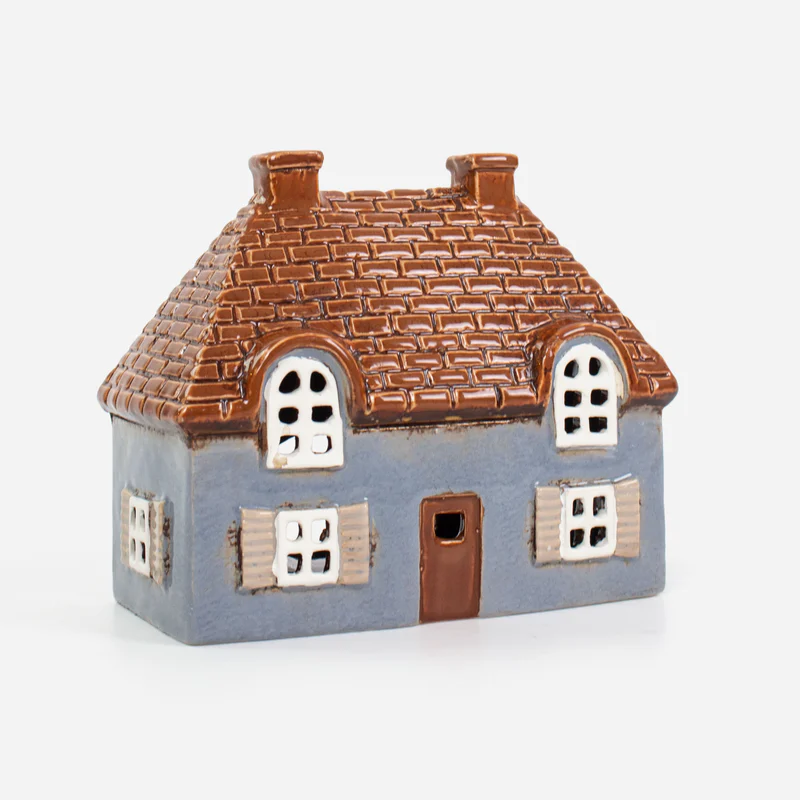 Small tealight house with a brown roof and blue body