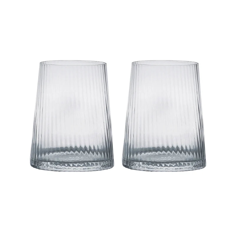 A pair of clear drinking glasses with a fine, vertical optic which runs up and down the glass