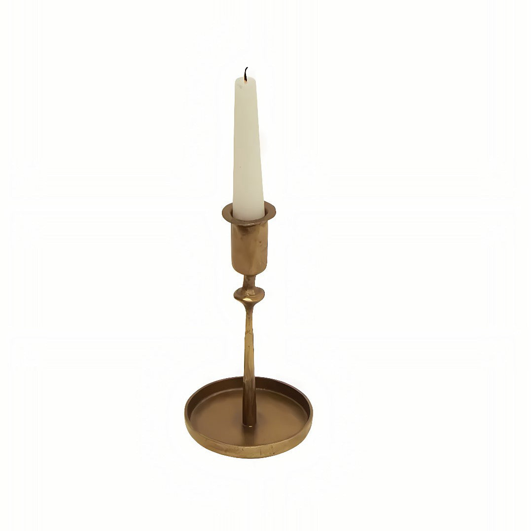 Brass candle holder with a white candle