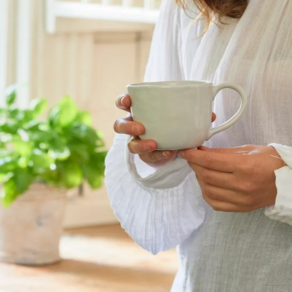 A white ceramic rustic mug