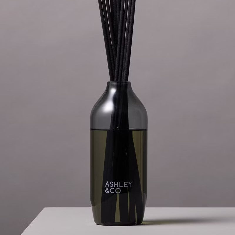 A black reed diffuser with the brand name 'Ashley & Co'