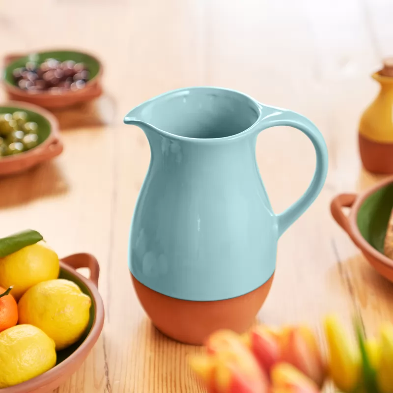 A blue glazed terracotta jug