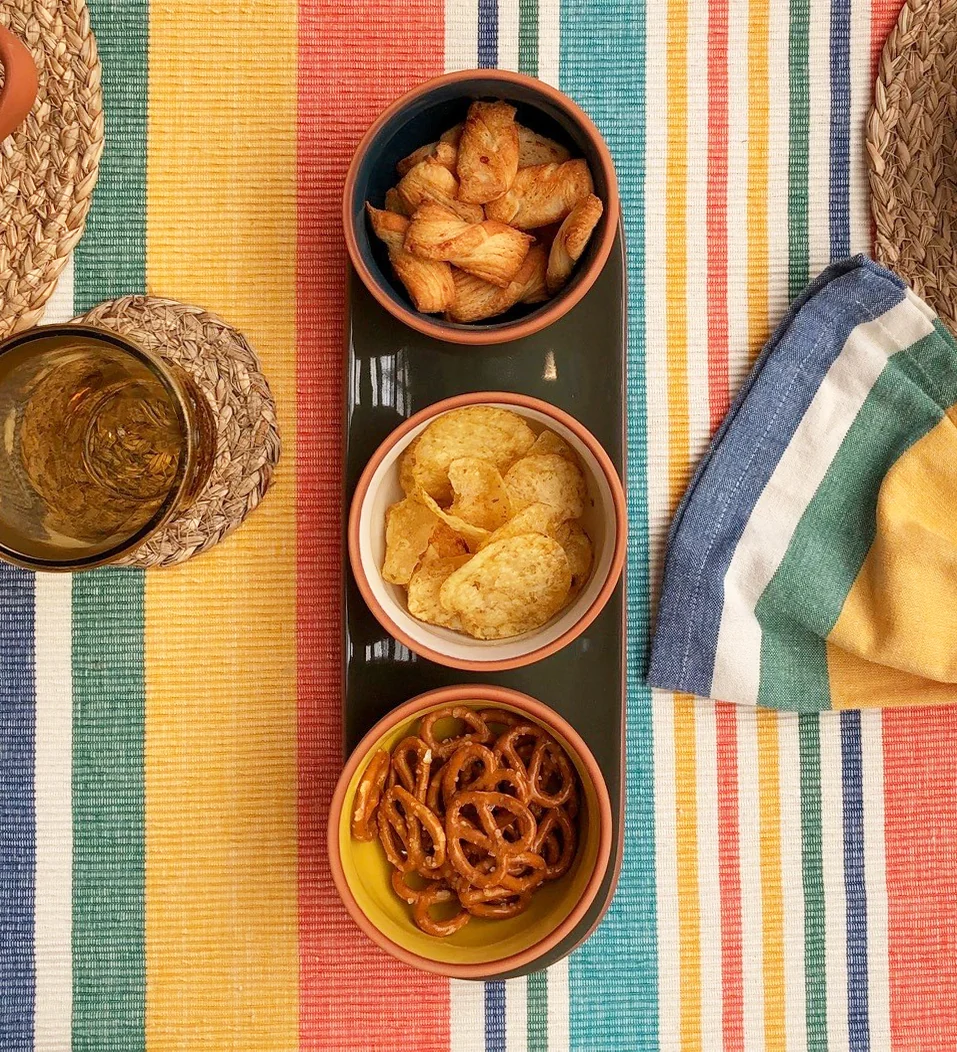 A set of three terracotta bowls on a tray