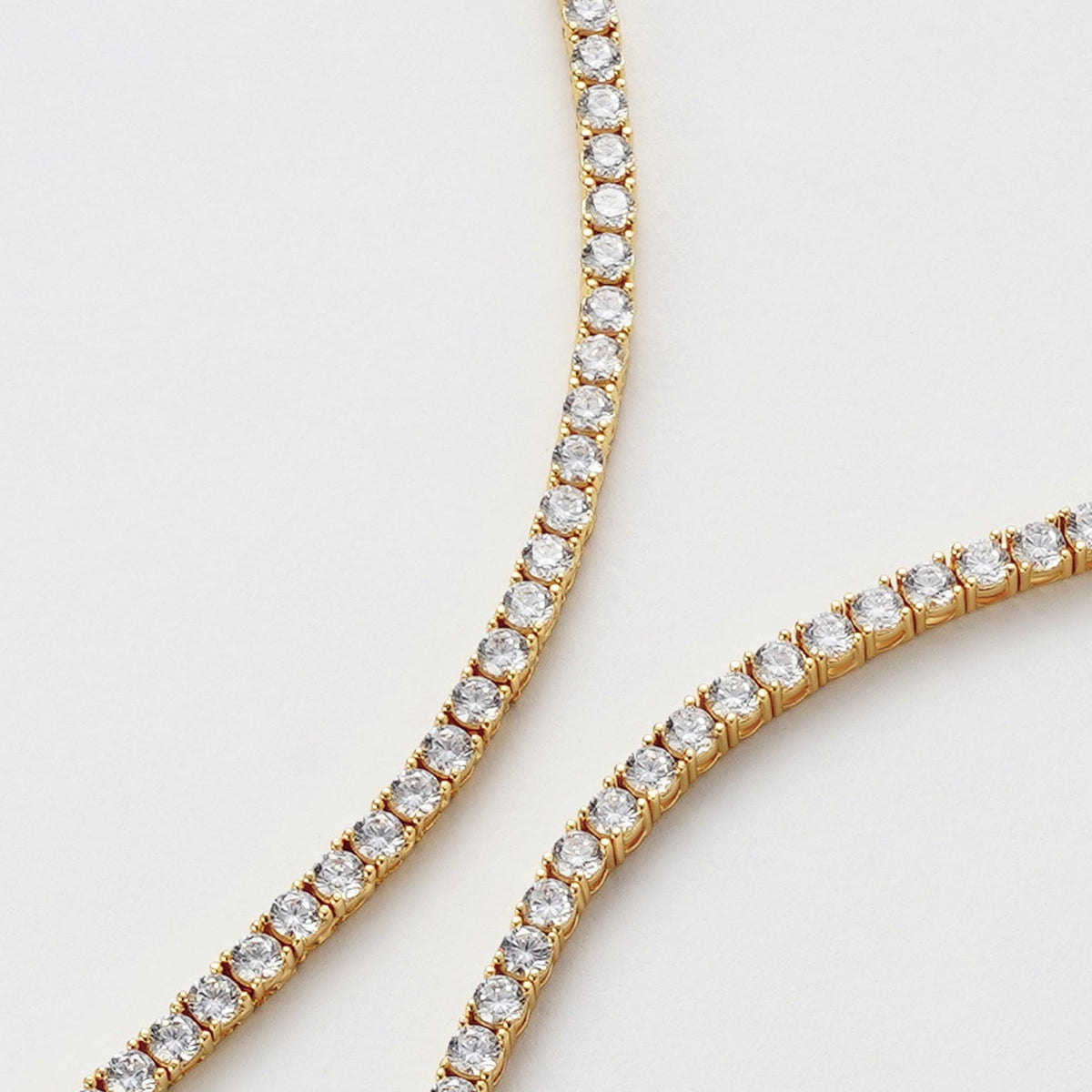 close up of a gold tennis bracelet