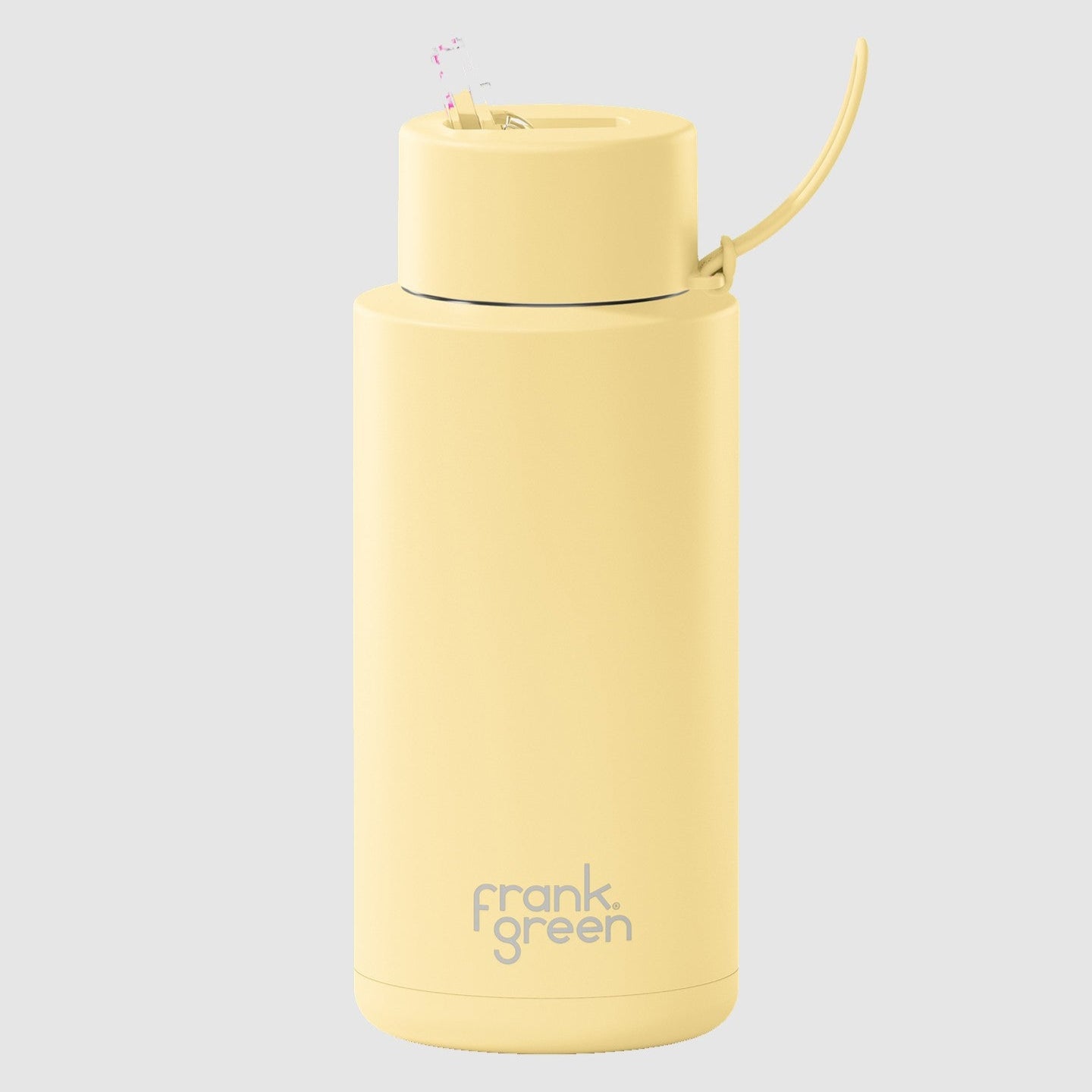 A yellow ceramic reusable water bottle with a straw lid, branded with 'frank green'.