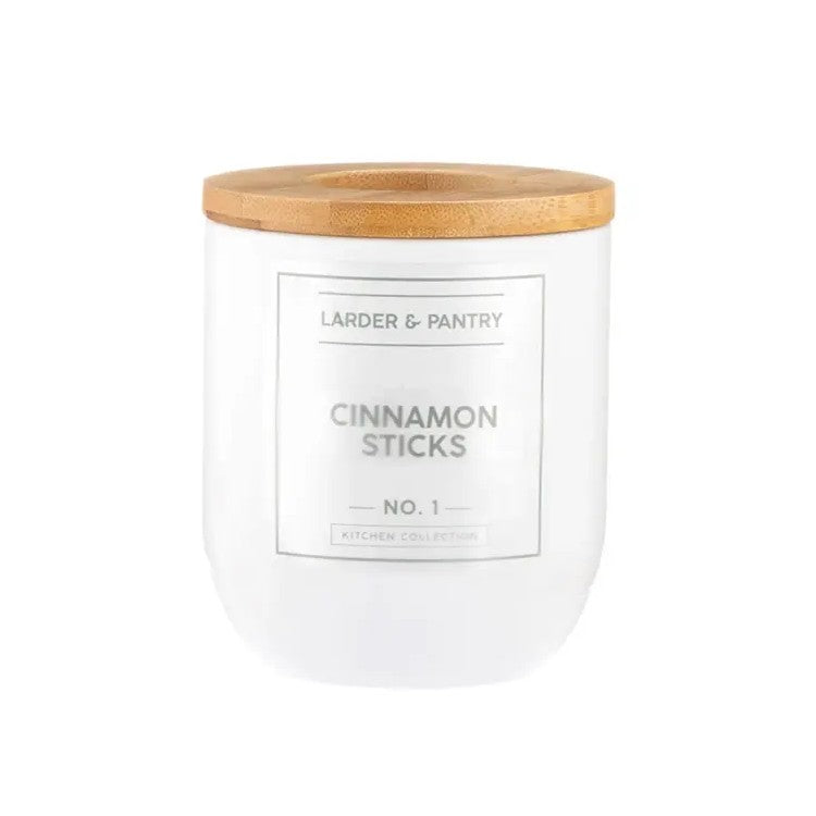 White container with wooden lid labeled 'Cinnamon Sticks' from 'Larder & Pantry'