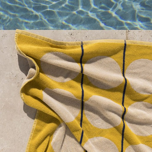 yellow towel next to pool