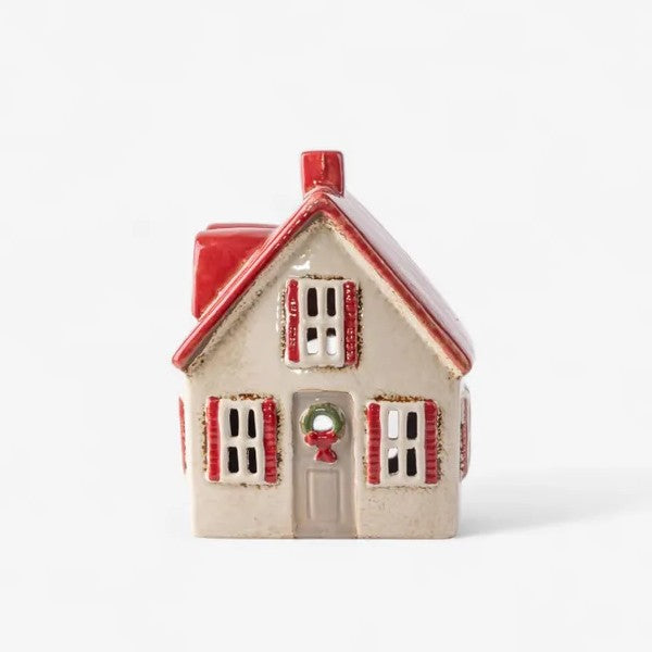 Small ceramic house with a red roof and white walls