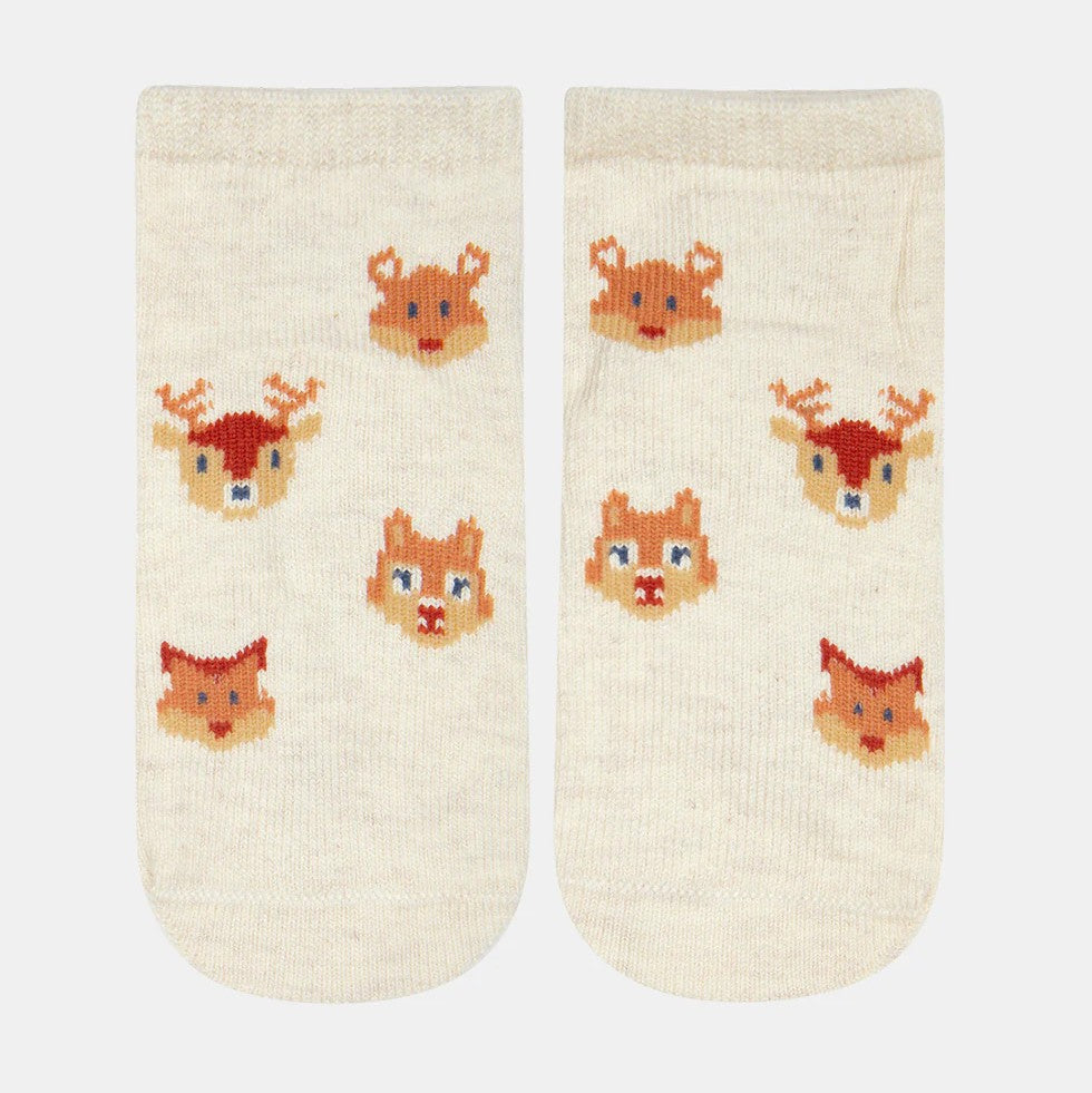 A pair of white baby socks with jacquard patterns of animals such as a deer and a fox