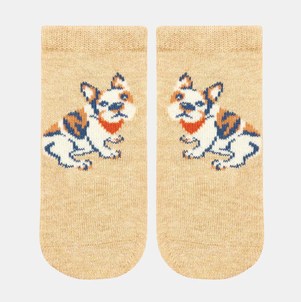 A pair of beige ankle socks with a jacquard pattern of a French Bulldog, featuring a hand linked toe and skid resistant sole grip.