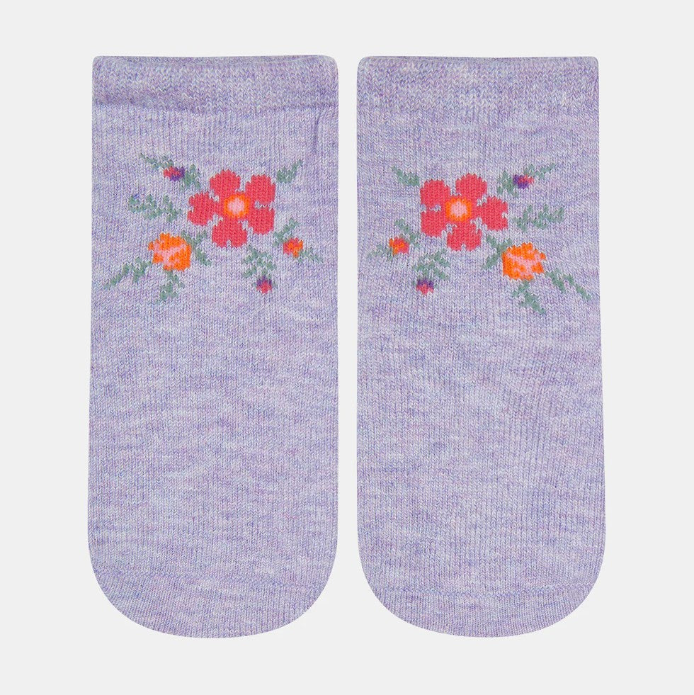A pair of purple baby socks with a floral jacquard pattern.