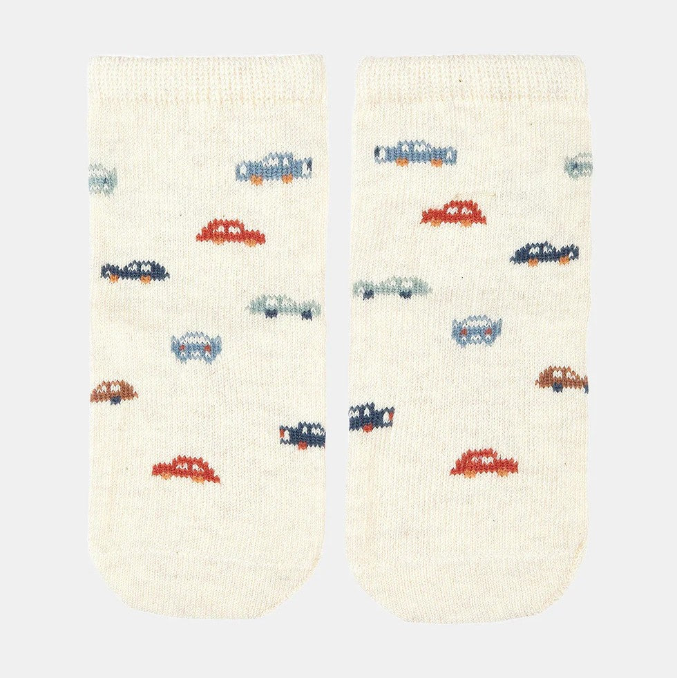A pair of white baby socks with a jacquard pattern featuring colorful cars.