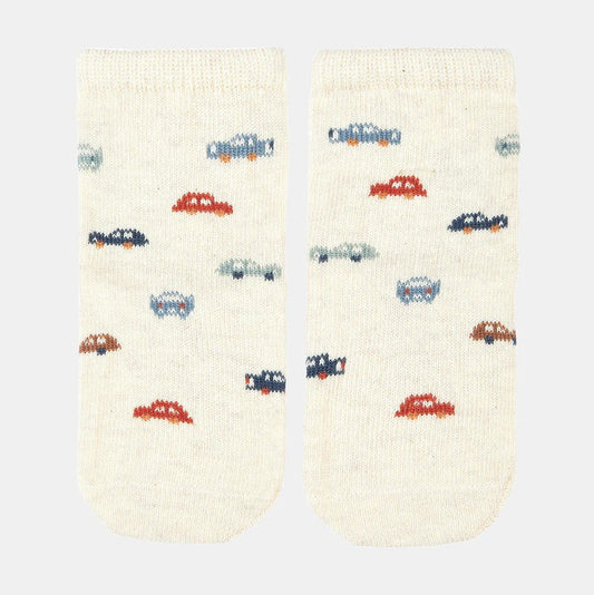A pair of white baby socks with a jacquard pattern featuring colorful cars.