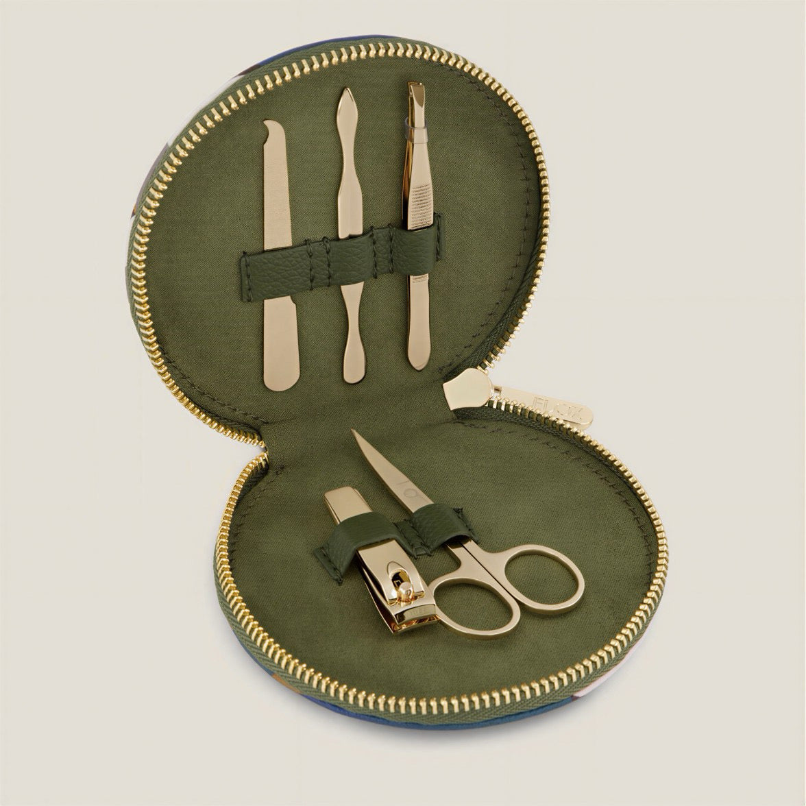 Manicure set with scissors, cuticle pliers, and nail clippers in a green case