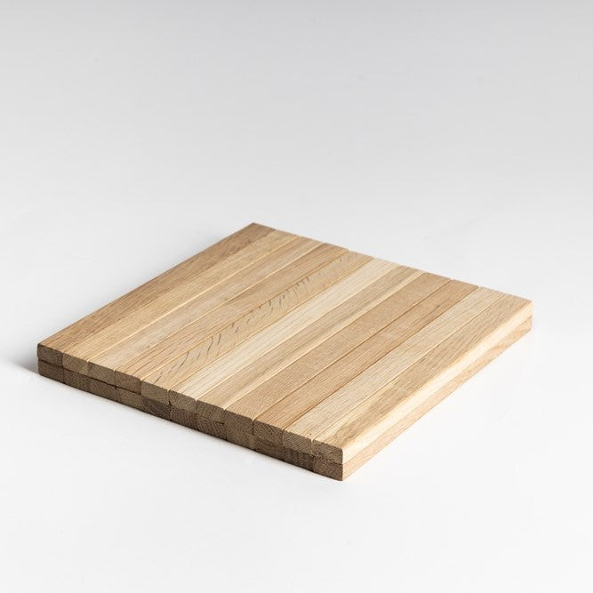 A beige arm chair side rest made of solid oak wood with suede backing, 