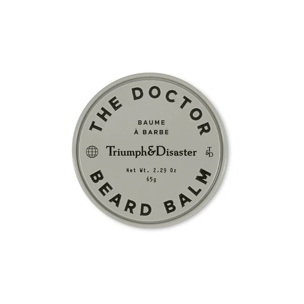 A container of 'The Doctor Beard Balm' by Triumph & Disaster with the product name and weight (65g) displayed on the lid.