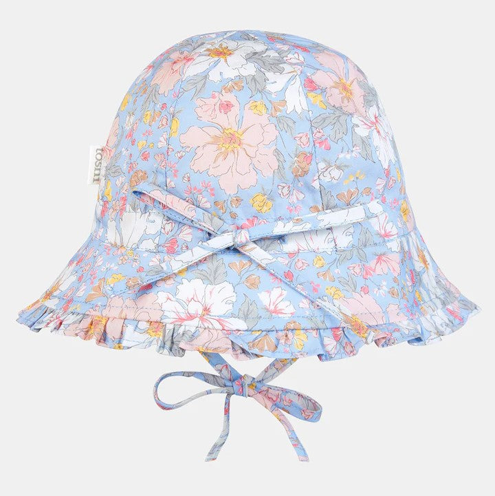 A floral patterned baby bell hat with a frilled border, featuring a head tie for adjustable sizing.