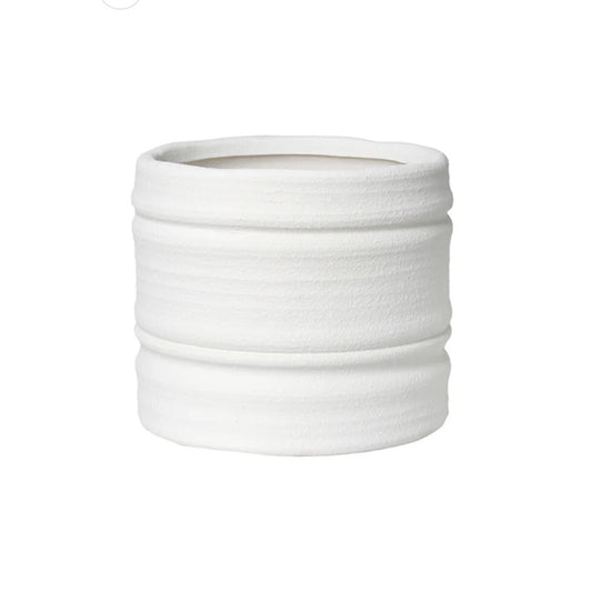 A white textured ceramic planter pot with horizontal ridges