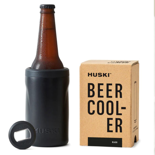 A black Huski Beer Cooler 2.0 placed next to its packaging box.