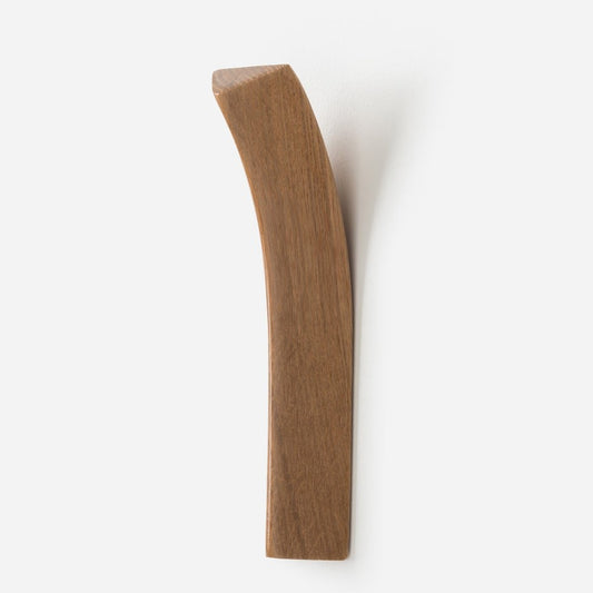 A wooden bow wall hook mounted on a white background.