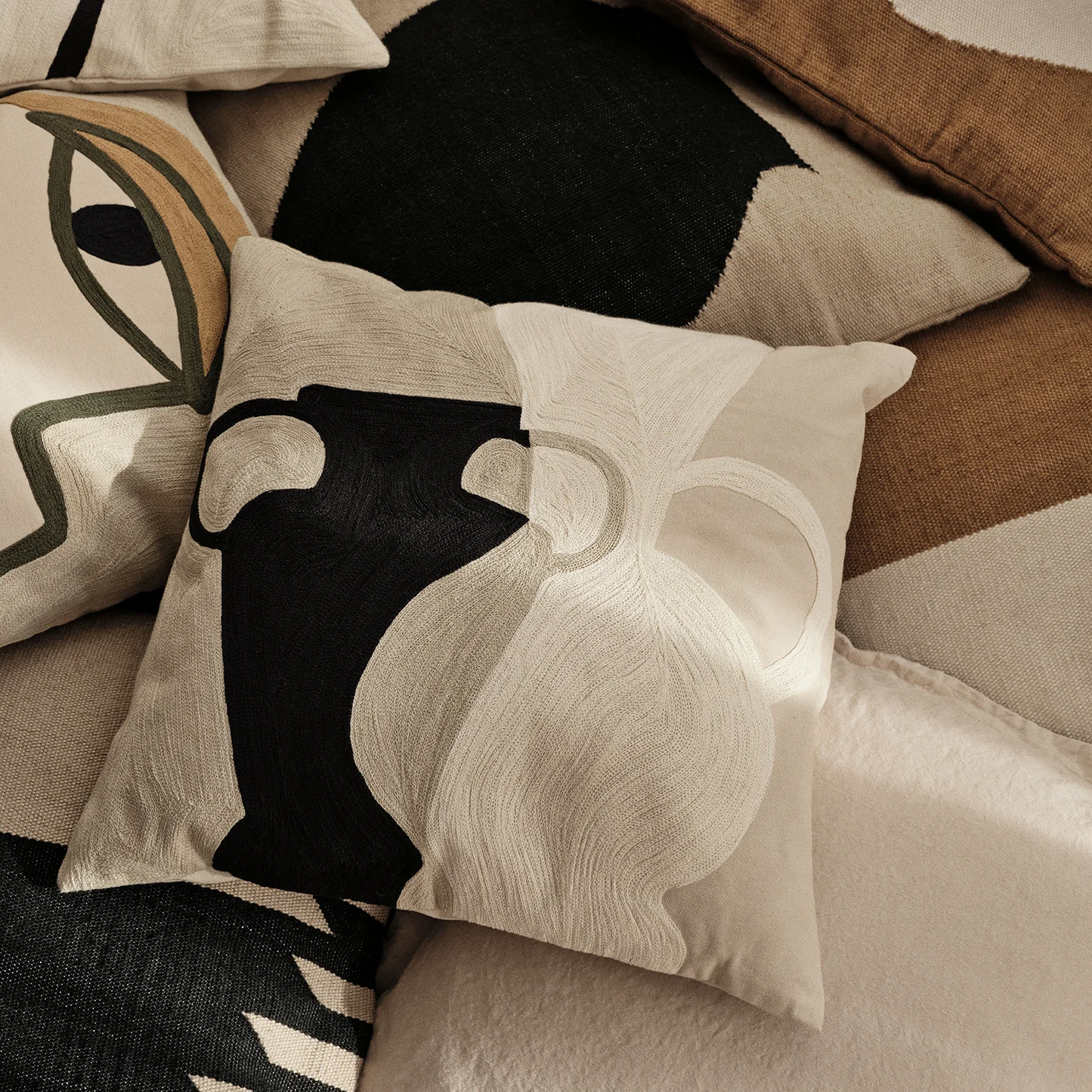 Cotton pillow with abstract patterns black white and cream 