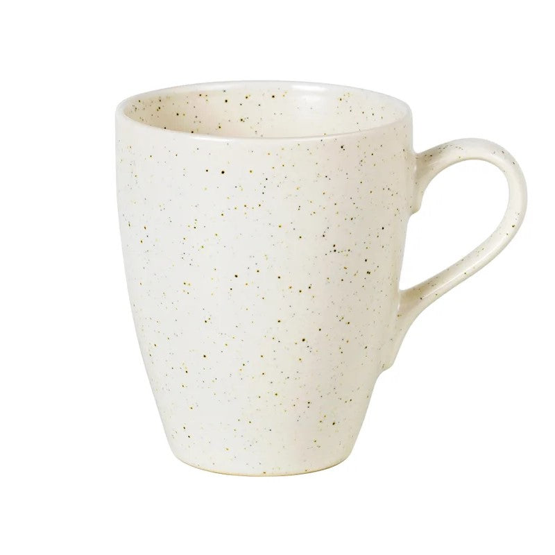 A beige speckled stoneware mug with a handle, part of the Broste Nordic Vanilla collection.