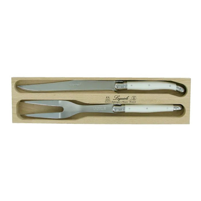 A carving set with two spoons and two forks, featuring stainless steel blades and white and colored resin handles with 'Andre Verdier Laguiole' branding on the handles, packaged in a wooden gift tray.