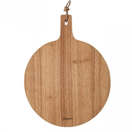 A round wooden cutting board made of oak with a handle on the top, featuring natural variations in the wood's tone and grain.