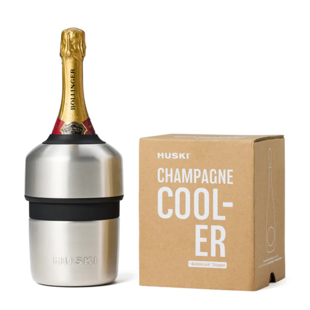 A stainless steel Huski Champagne Cooler with a bottle placed in it, next to its packaging box.