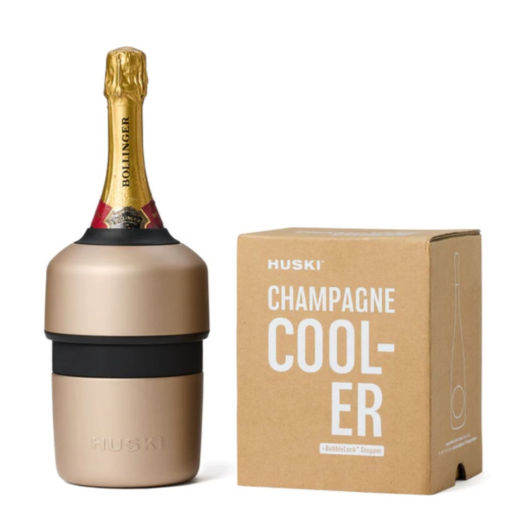 A Champagne colour Huski Champagne Cooler fitted with a bottle, displayed alongside its packaging box.