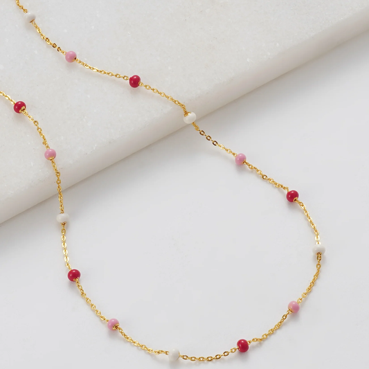 Gold necklace with red and pink beads