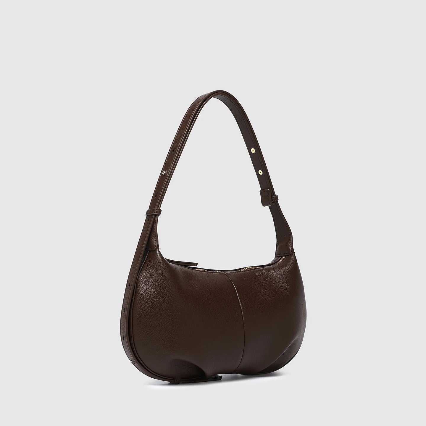 Brown vegan leather handbag on a light gray background