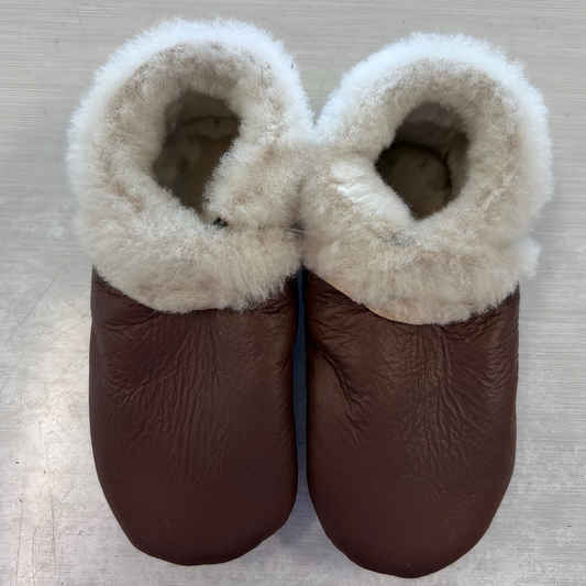 Pair of brown leather slippers with white fur trim