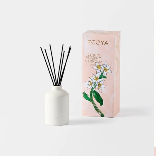A white ecoya ceramic diffuser bottle with black reeds,