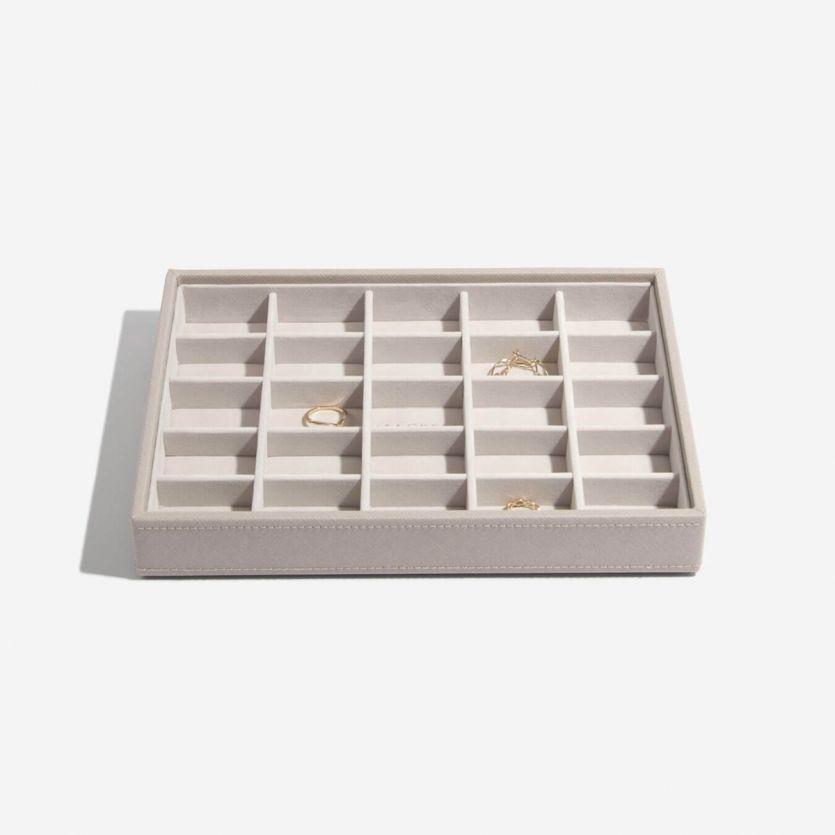 A taupe and grey velvet jewellery tray with 25 sections