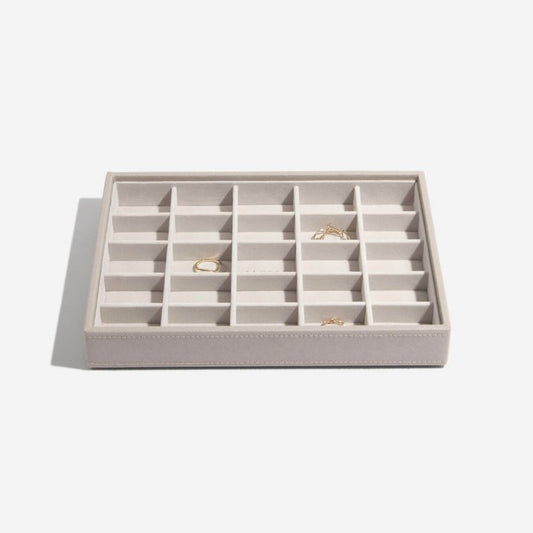 A taupe and grey velvet jewellery tray with 25 sections