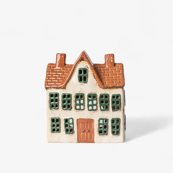 Small ceramic house with a brown roof and green windows