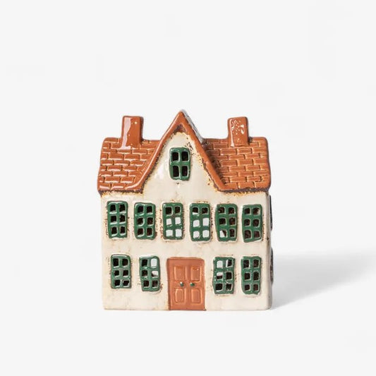 Small ceramic house with a brown roof and green windows