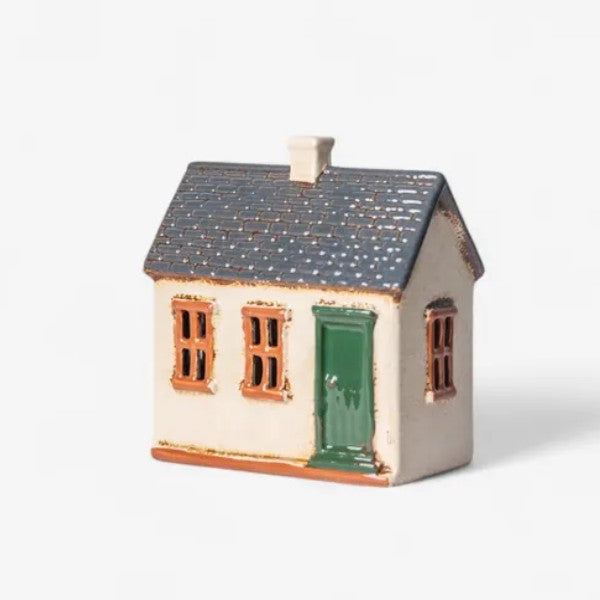 Small ceramic house with a green door
