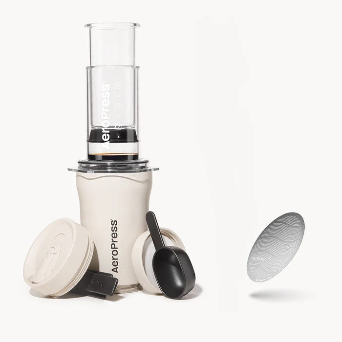 Aeropress coffee maker with components on a white background