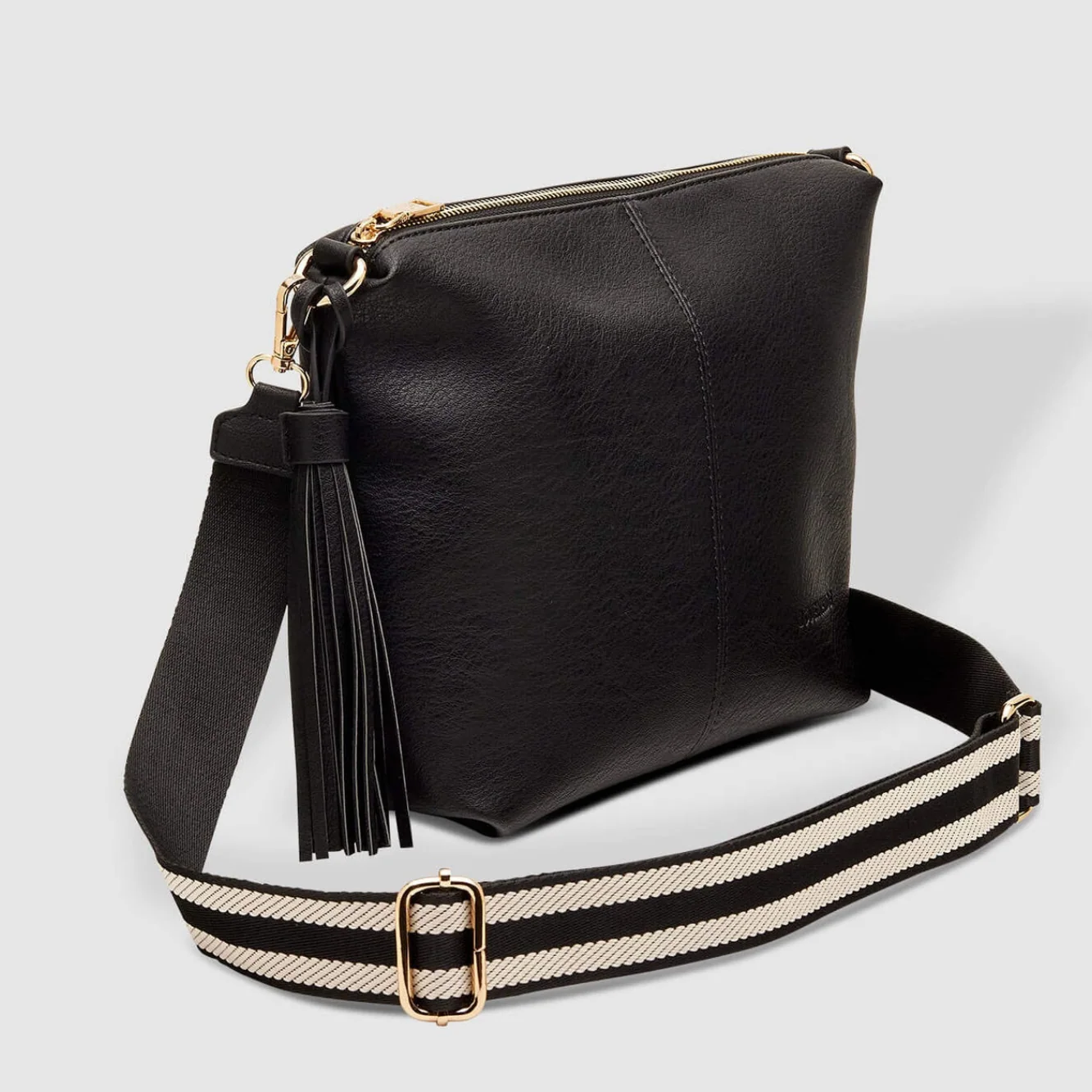 Black leather handbag with a striped strap