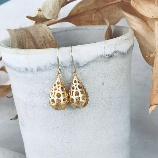 Gold earrings with intricate designs 