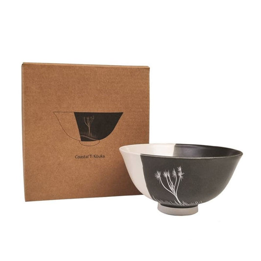 A white porcelain bowl with a black exterior, featuring a floral design on the inside, accompanied by its packaging box.