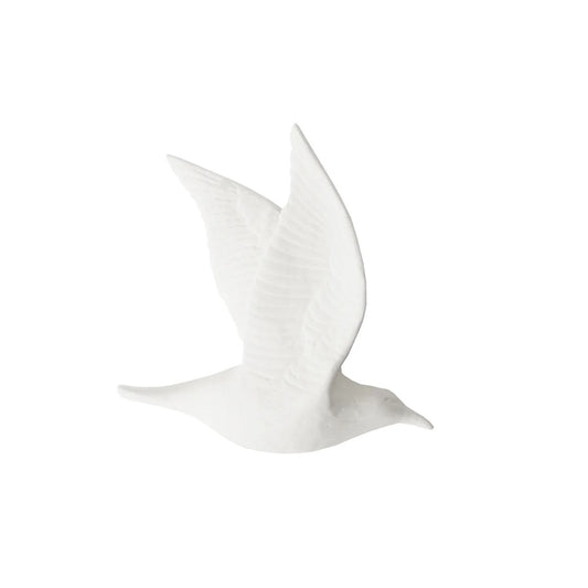 A white fine bone china bird wall art in a flying pose with closed wings.