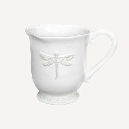 White ceramic mug with dragonfly design on a white background