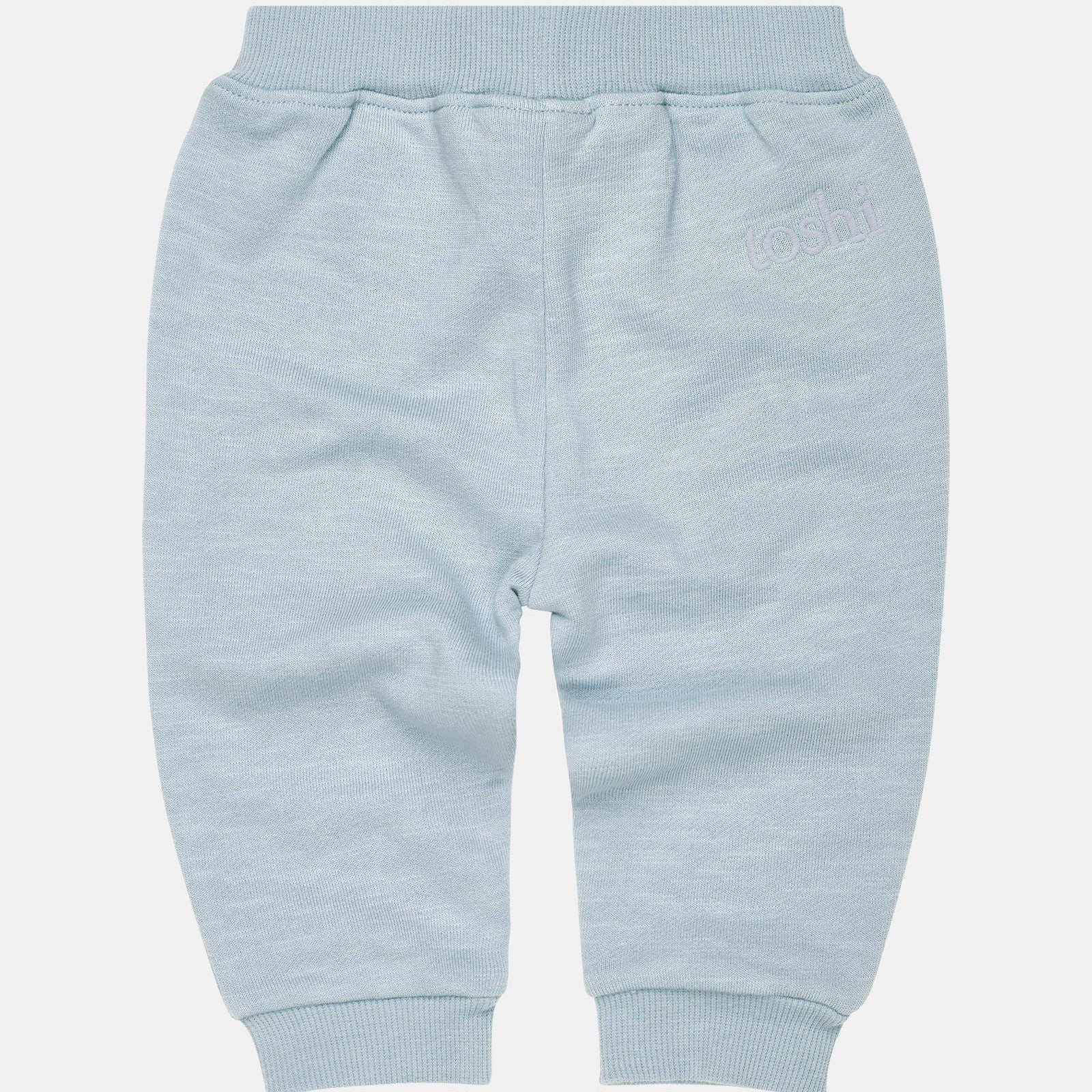A pair of blue Toshi Dreamtime Organic Sweater and Trackpants for babies, with an elasticized waist and embroidered Toshi logo.