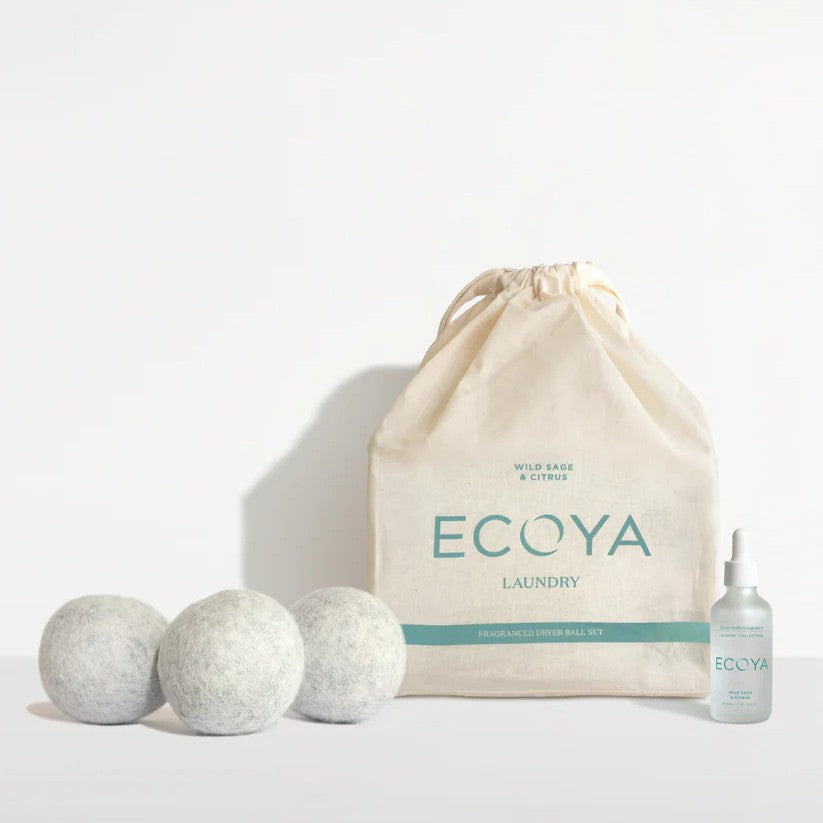A set of Ecoya branded laundry dryer balls with a citrus fragrance, displayed alongside a natural-toned drawstring bag and a small bottle of fragrance dropper.
